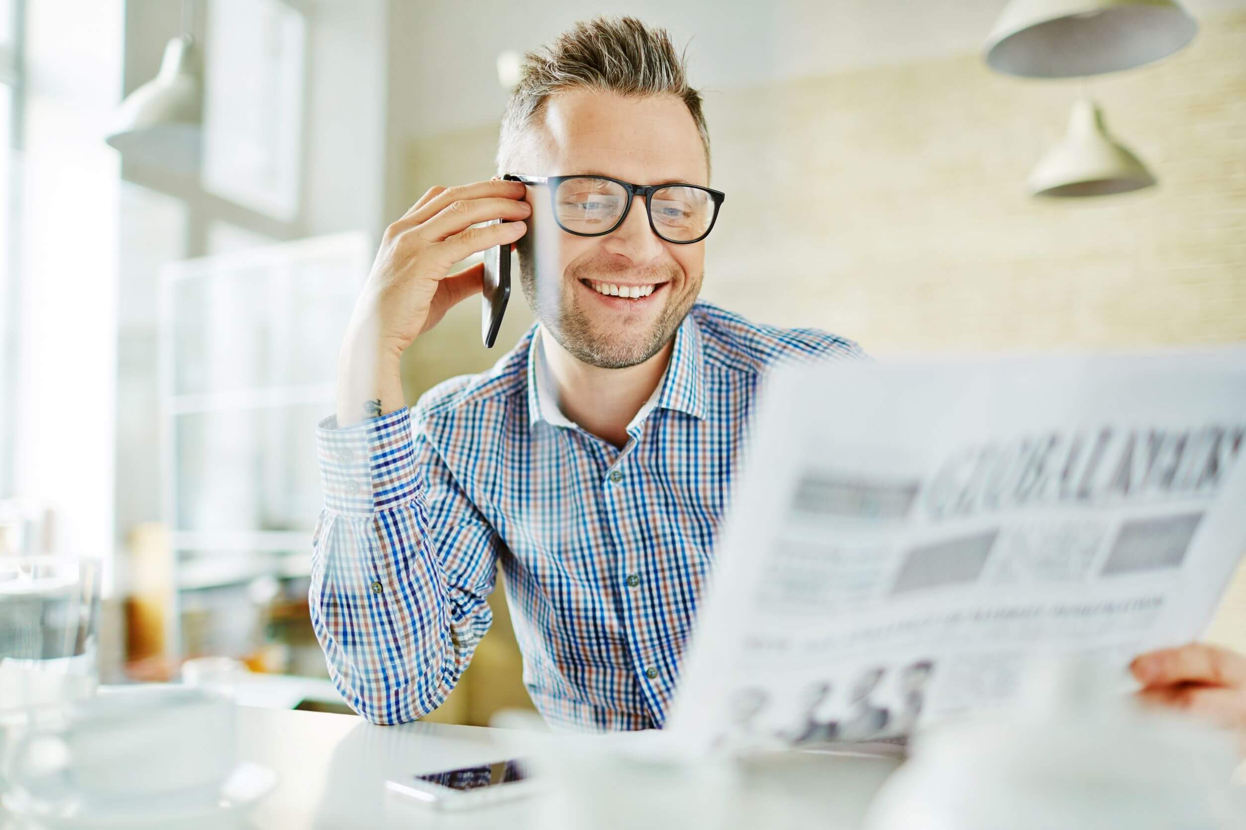 Photo graph of man with glasses reading newspaper (writing a good title). 